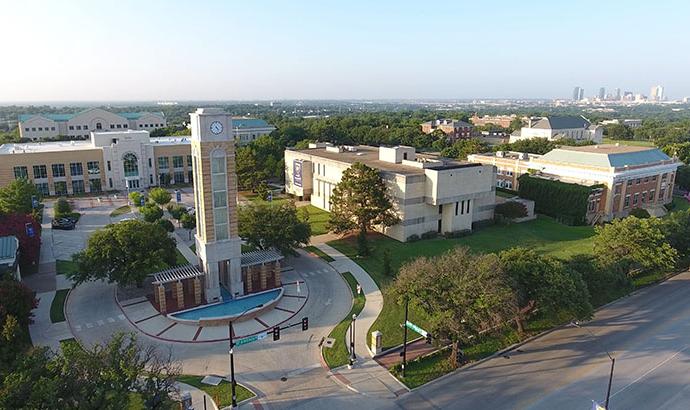 the university clocktower and campus entrance as seen from above
